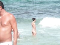 Gentle Waves Lap at Her Feet Along a Natural Shoreline