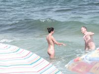 Gentle Waves Lap at Her Feet Along a Natural Shoreline