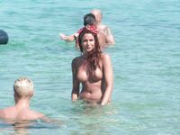 Gentle Waves Lap at Her Feet Along a Natural Shoreline
