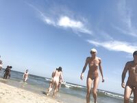 Gentle Waves Lap at Her Feet Along a Natural Shoreline