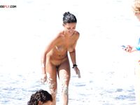 Three Nudists Stepping from the Sea by Rocky Cliffs