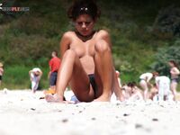 A model showcasing her natural confidence during a sun-drenched, clothing-free session.