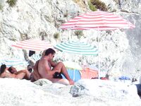 From Sea to Pebble Shore Beside a Yellow Umbrella and Towel