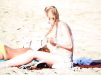 One Woman with Pink Hair on a Topless Beach