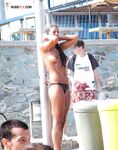 Outdoor Shower Refresh Beside a Stone Wall at a Topless Beach