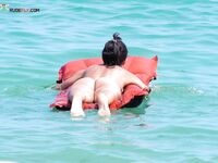 Resting Face Down on a Red Inflatable in Clear Turquoise Water