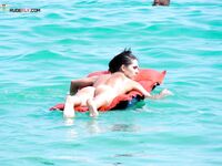 Resting Face Down on a Red Inflatable in Clear Turquoise Water