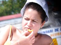 Sun Hat, Bright Light, and a Bite of Orange Outdoors
