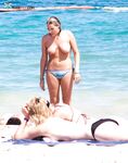 Feeling the energy of the summer sun while relaxing without a top.