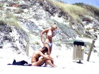 Three Topless Women Walking on the Beach