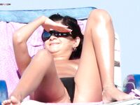 The charm of a European seaside day, spent topless under the glowing sun.