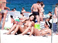Embracing the wind and the sea in a state of total nudity on a deserted beach.