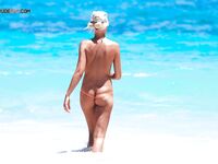 Finding the perfect spot for sunbathing without a top on the golden sand. 5