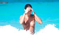 Finding the perfect spot for sunbathing without a top on the golden sand. 5