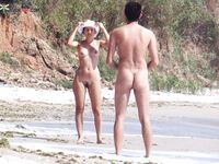 Tossing a Beach Ball Between Two Nudists on the Sand