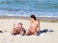 A lady enjoying the ultimate sunbathing experience at a clothing-optional spot. 3