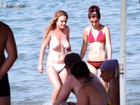 A breathtaking gaze toward the sea, enjoying the air in a topless fashion. 2