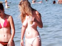 A breathtaking gaze toward the sea, enjoying the air in a topless fashion. 2