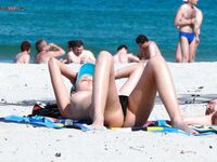 Capturing the graceful, natural movements of a woman at a naturist beach. 4