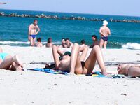 Capturing the graceful, natural movements of a woman at a naturist beach. 4