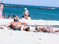 Capturing the graceful, natural movements of a woman at a naturist beach. 4