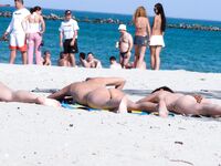 Capturing the graceful, natural movements of a woman at a naturist beach. 4