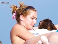 A spontaneous topless shoot on a boardwalk overlooking the ocean waves. 3