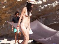 Straw Hat and Blue Cooler on a Rocky Nude Beach Walk