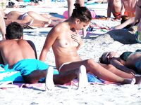 En una toalla con braguita blanca entre bañistas al sol