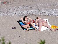 Nude Beach Shoreline with a Pink and Purple Towel