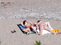 Nude Beach Shoreline with a Pink and Purple Towel