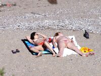 Nude Beach Shoreline with a Pink and Purple Towel