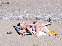 Nude Beach Shoreline with a Pink and Purple Towel