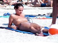 Two Women Pause at a Quiet Topless Beach Shoreline
