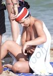 A Bright Smile on Her Topless Beach Walk in Leopard Print