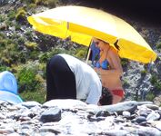 Gesprek onder zandsteenrotsen op een rustig naaktstrand