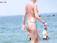 A mature nudist lady seemed very keen to hide her large beautiful breasts as she emerged from the sea. 2