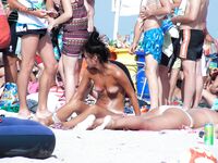 By the Sea in a White Bucket Hat on a Relaxed Nude Beach