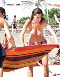 She Wringes Water From Her Hair on a Sunlit Topless Beach