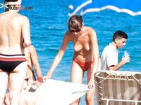One Woman Topless on a Crowded Beach with Headband