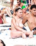 One Woman Topless on a Crowded Beach with Headband