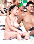 One Woman Topless on a Crowded Beach with Headband