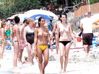 The natural beauty of a lady sunbathing topless on a quiet, sunny pier. 2