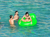 Drifting Together on a Green Inflatable Ring in Turquoise Water