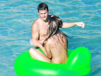 Drifting Together on a Green Inflatable Ring in Turquoise Water