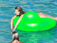 Drifting Together on a Green Inflatable Ring in Turquoise Water