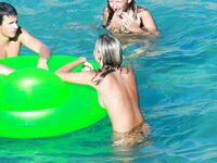 Drifting Together on a Green Inflatable Ring in Turquoise Water
