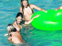 Drifting Together on a Green Inflatable Ring in Turquoise Water