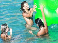 Drifting Together on a Green Inflatable Ring in Turquoise Water