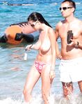 A lady enjoying the refreshing sea breeze in a natural, topless state. 4